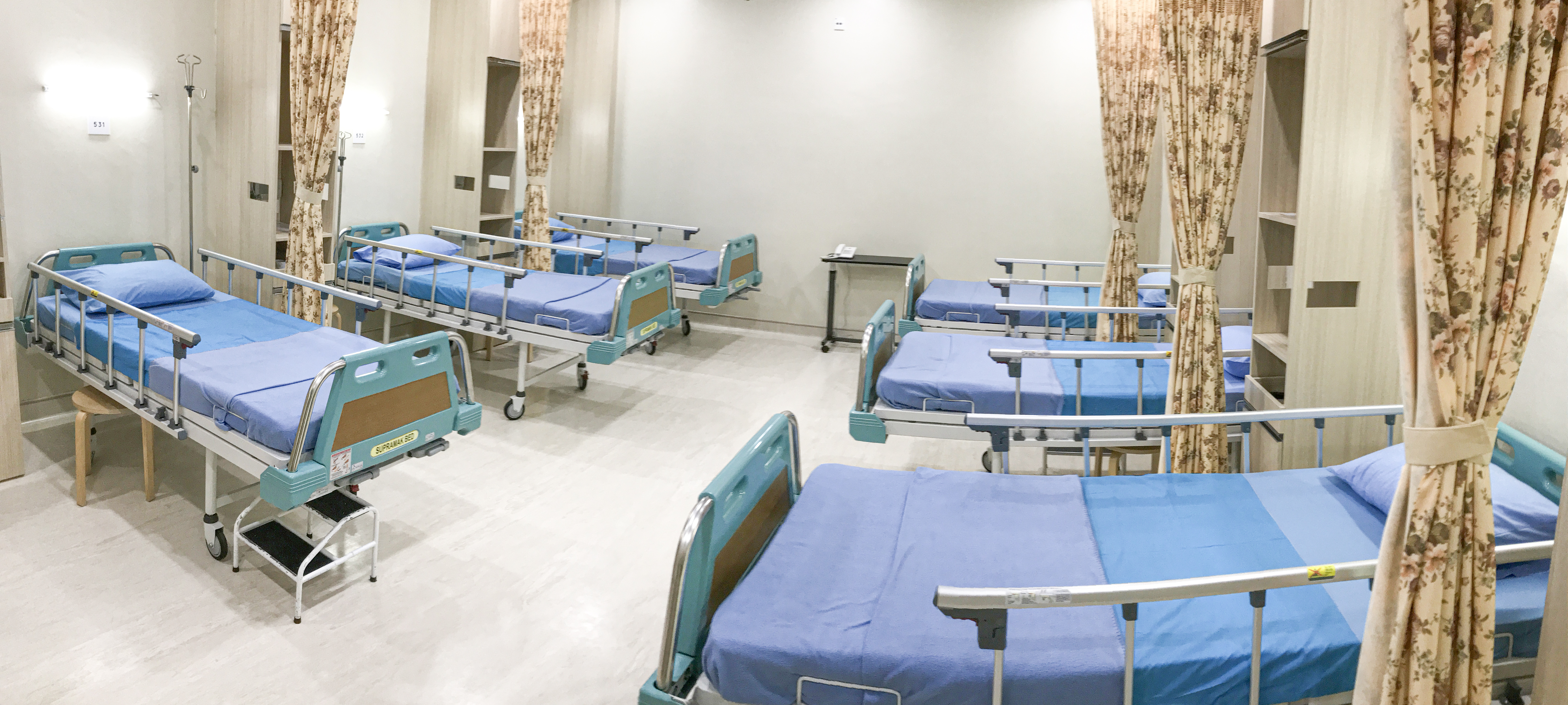 Standard (Kelas III) room with multiple beds and basic facilities